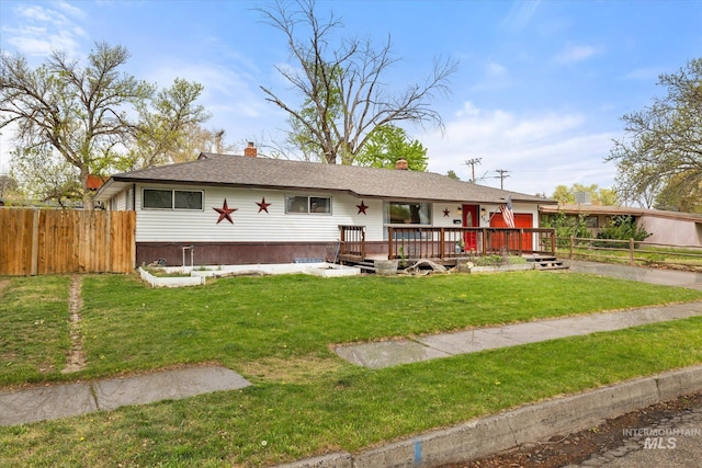 single story home with a deck, fence, a chimney, and a front yard