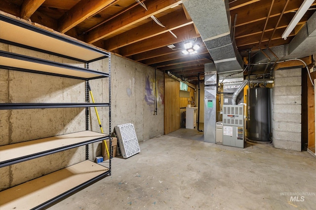 unfinished below grade area with heating unit, washer / dryer, and gas water heater