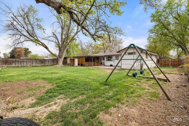 view of yard with a fenced backyard, a playground, and a patio area