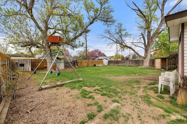 view of yard with a playground and a fenced backyard