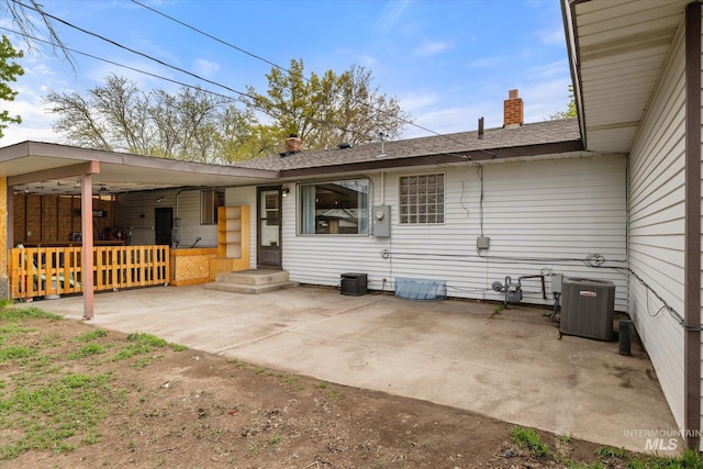 back of house featuring a patio, central AC, and a chimney