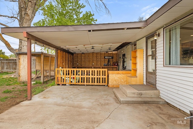 view of patio featuring fence and an attached carport