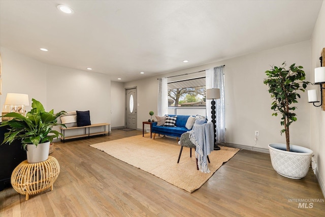 living area with recessed lighting, baseboards, and wood finished floors