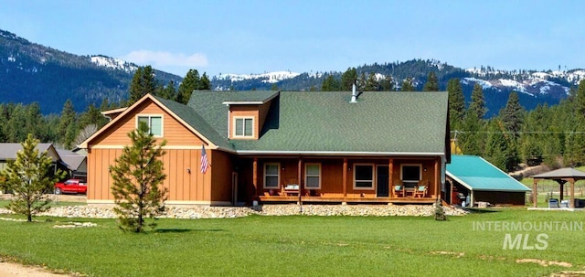 3 Boone Rd, Garden Valley, ID 83622 - back of property featuring board and batten siding, a lawn, a porch, and a mountain view