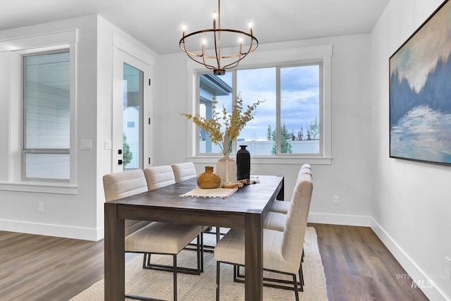 dining area featuring dark hardwood / wood-style flooring and a notable chandelier