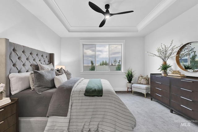 bedroom with a raised ceiling, ornamental molding, light carpet, and ceiling fan