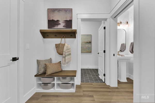 mudroom with hardwood / wood-style flooring and sink