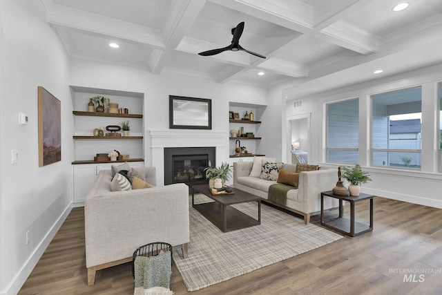 living room featuring dark hardwood / wood-style floors, built in features, and beam ceiling