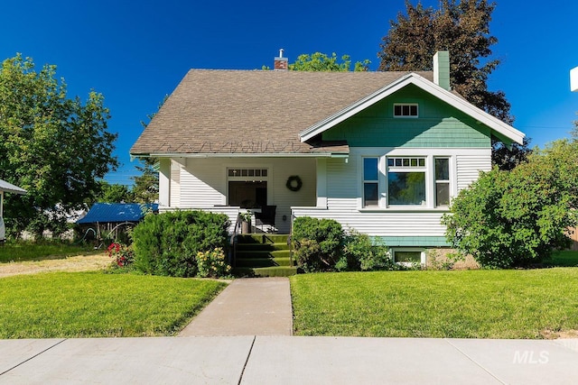 view of front of house with a porch and a front yard