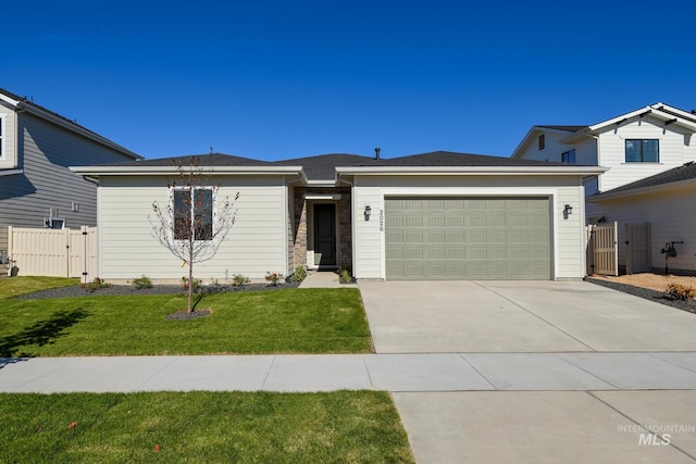 view of front of property featuring concrete driveway, a gate, a garage, and a front yard