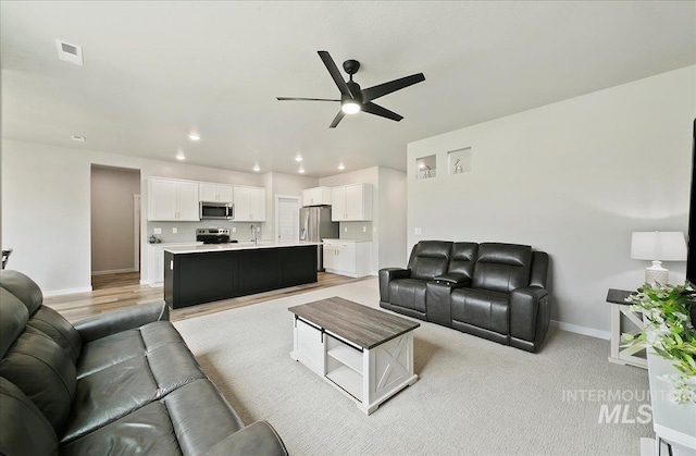 5094 W Avilla Dr, Meridian, ID 83646 - living room featuring a ceiling fan, baseboards, and recessed lighting