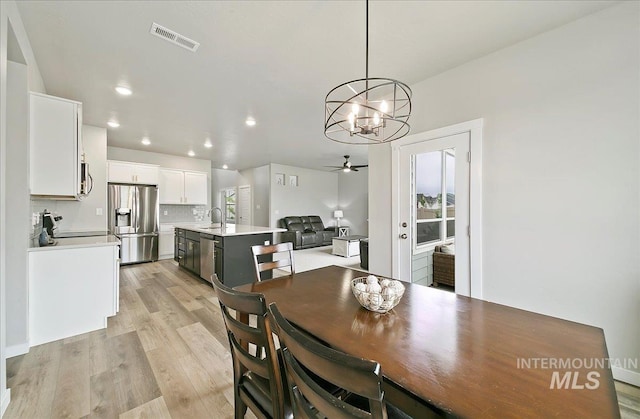 5094 W Avilla Dr, Meridian, ID 83646 - dining space with a chandelier, ceiling fan, light wood-type flooring, and recessed lighting