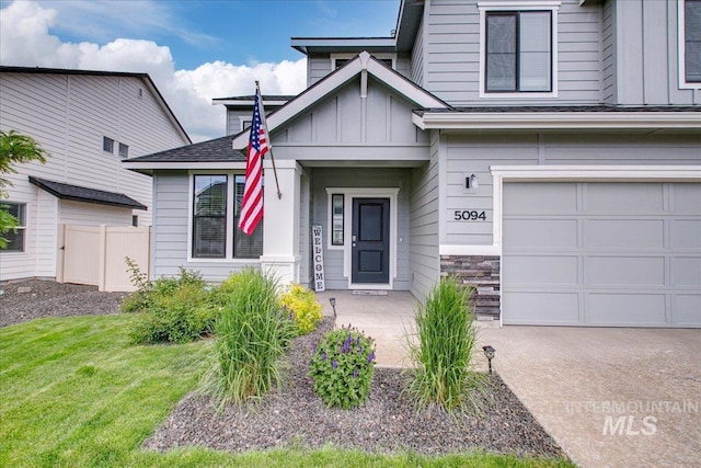 5094 W Avilla Dr, Meridian, ID 83646 - view of front of house with board and batten siding, an attached garage, concrete driveway, and stone siding