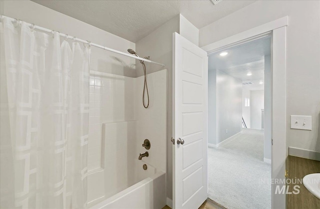 5094 W Avilla Dr, Meridian, ID 83646 - bathroom featuring shower / tub combo, baseboards, and a sink