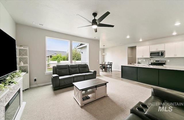 5094 W Avilla Dr, Meridian, ID 83646 - living room with ceiling fan, baseboards, and recessed lighting