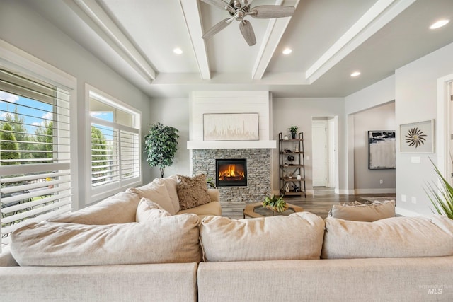 1071 W Rose Quartz St, Kuna, ID 83634 - living area with a stone fireplace, a ceiling fan, recessed lighting, beam ceiling, and baseboards