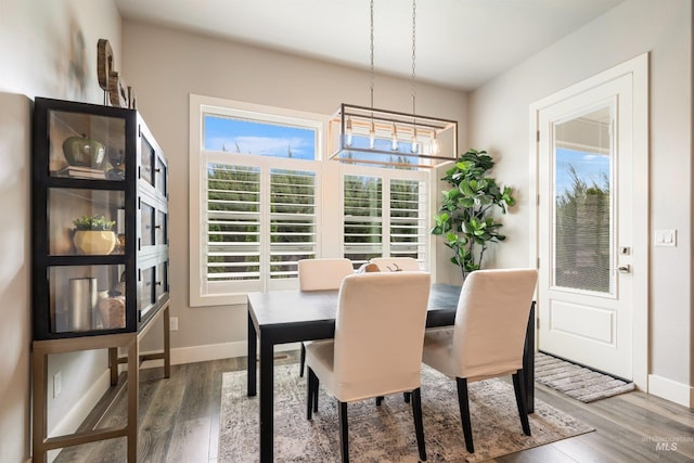 1071 W Rose Quartz St, Kuna, ID 83634 - dining area with baseboards, wood finished floors, and a chandelier