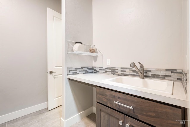 1071 W Rose Quartz St, Kuna, ID 83634 - bathroom with vanity, decorative backsplash, tile patterned floors, and baseboards