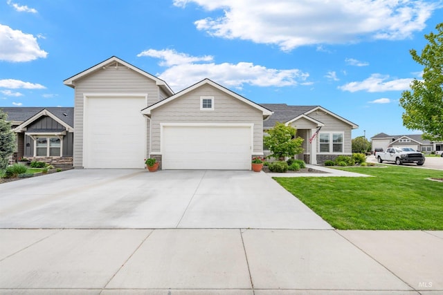 1071 W Rose Quartz St, Kuna, ID 83634 - view of front of property featuring an attached garage, a front lawn, driveway, and stone siding