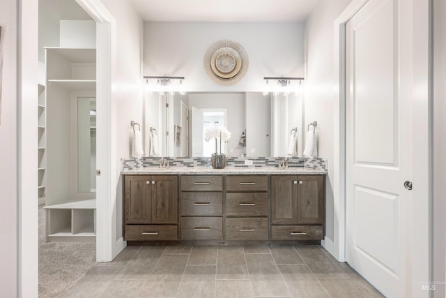 1071 W Rose Quartz St, Kuna, ID 83634 - bathroom featuring double vanity, backsplash, and tile patterned floors