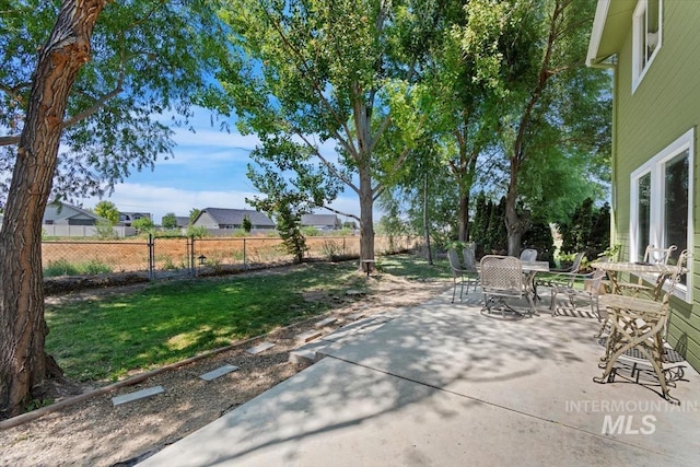 view of patio / terrace featuring fence and outdoor dining area