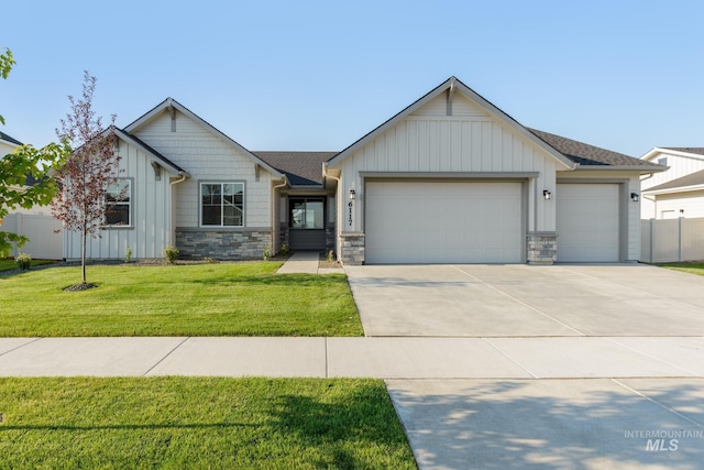 view of front of home with a garage and a front lawn