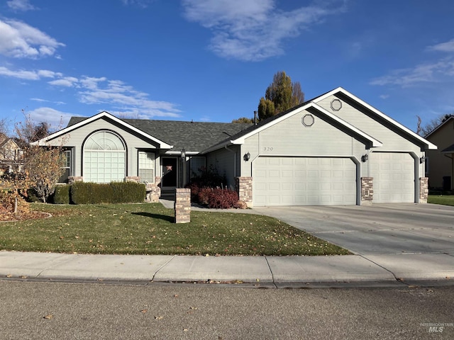 ranch-style home featuring a garage and a front yard