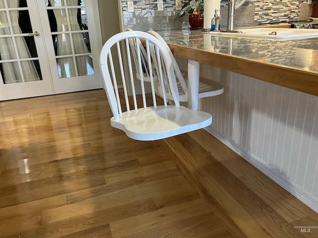 dining space featuring hardwood / wood-style flooring and sink