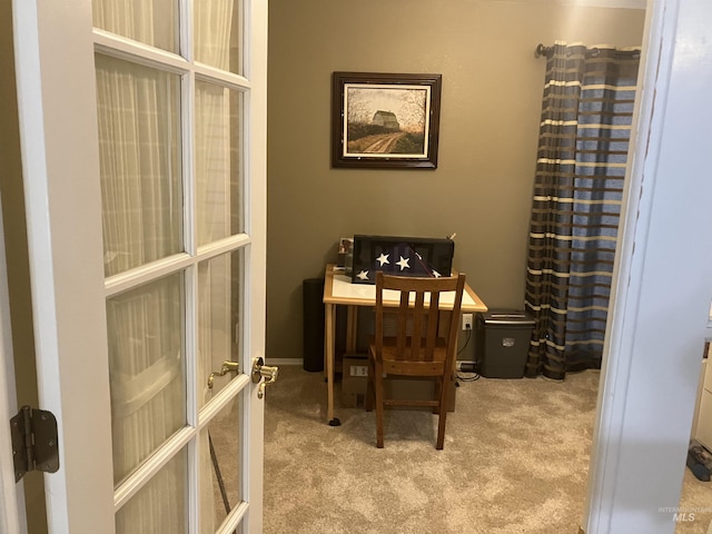 office area featuring french doors and light carpet