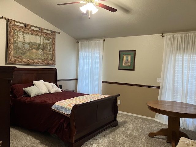 bedroom with a ceiling fan, light carpet, vaulted ceiling, and baseboards