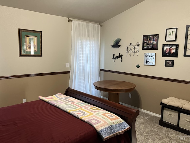 carpeted bedroom with lofted ceiling