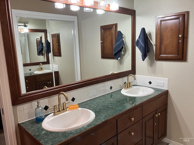 bathroom featuring vanity and backsplash