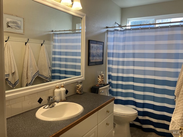 bathroom with vanity, toilet, walk in shower, and decorative backsplash