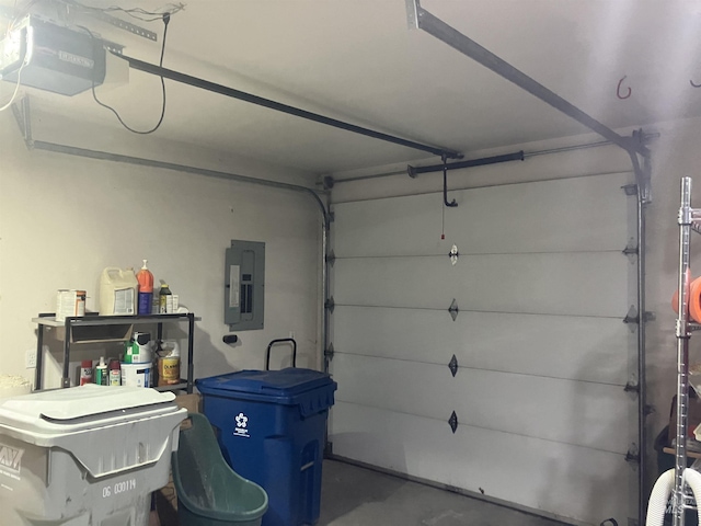 garage with electric panel and a garage door opener