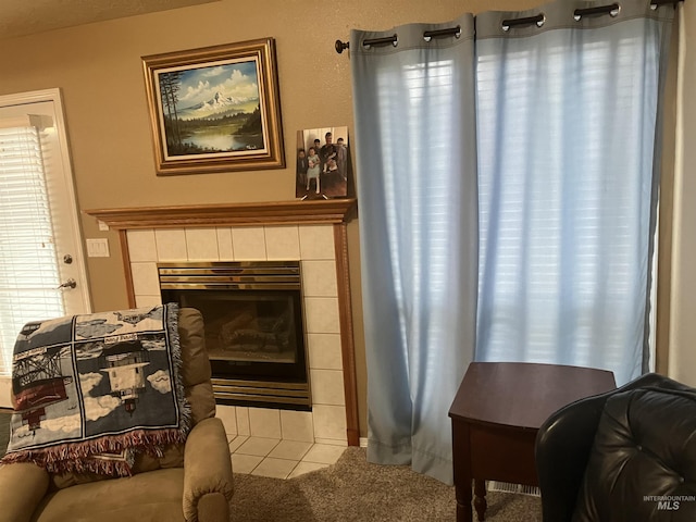 sitting room featuring carpet and a fireplace