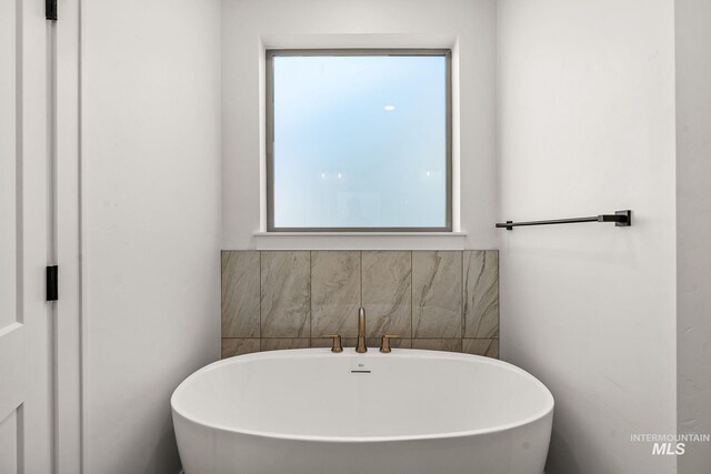 1724 Black Elm, Star, ID 83669 - bathroom featuring a soaking tub and a healthy amount of sunlight
