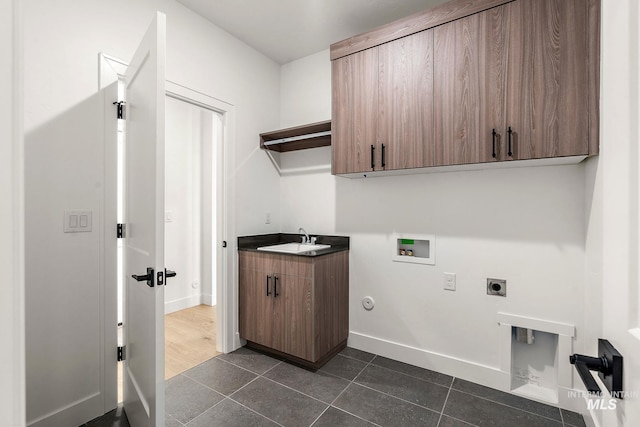 1724 Black Elm, Star, ID 83669 - laundry room featuring hookup for a washing machine, a sink, dark tile patterned flooring, hookup for an electric dryer, and cabinet space