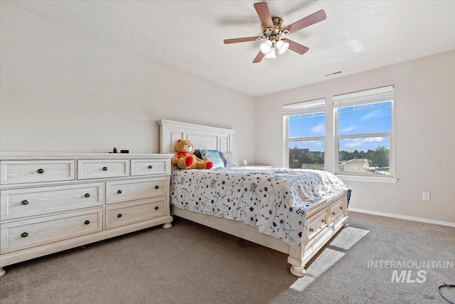 bedroom featuring ceiling fan, a textured ceiling, and carpet floors