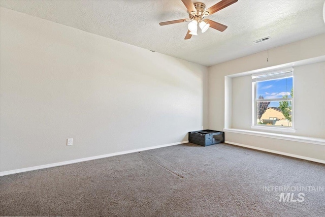 unfurnished room with ceiling fan, a textured ceiling, and carpet floors