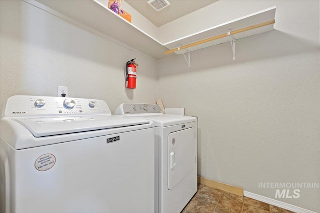 washroom with tile patterned floors and washing machine and clothes dryer