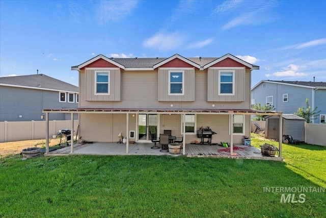 rear view of house featuring a storage shed, a patio area, and a yard