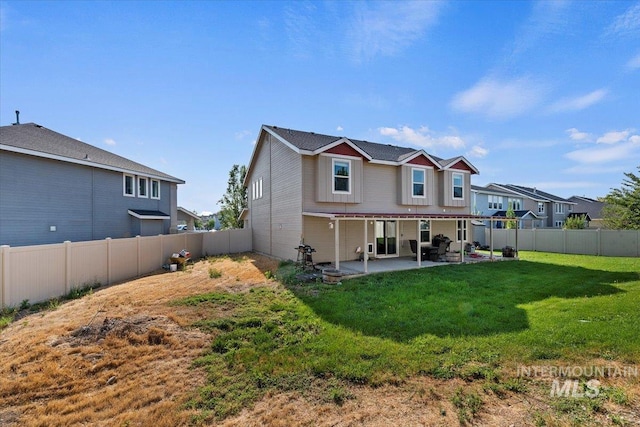 back of property featuring a patio area and a yard