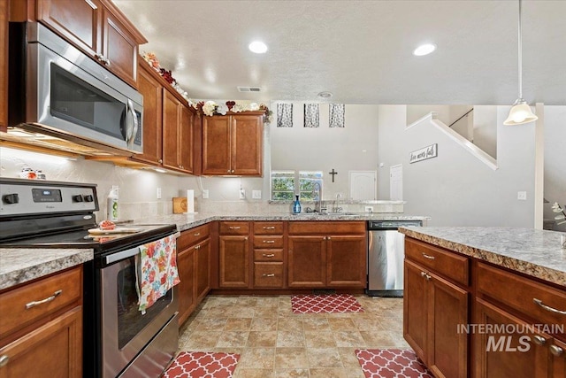 kitchen featuring pendant lighting, appliances with stainless steel finishes, sink, a textured ceiling, and light tile patterned flooring