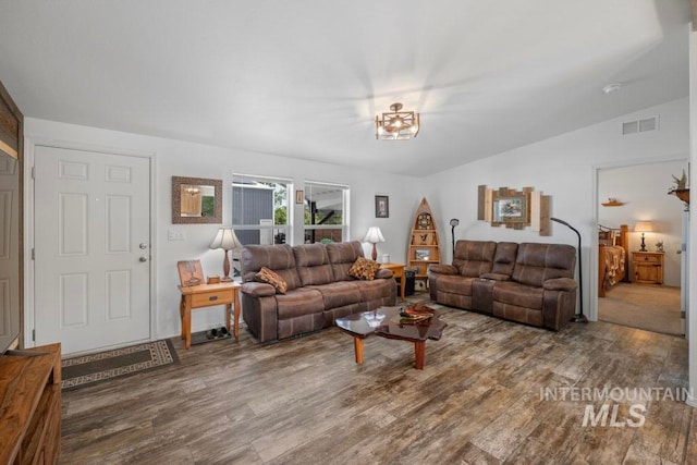 living area featuring wood finished floors and vaulted ceiling