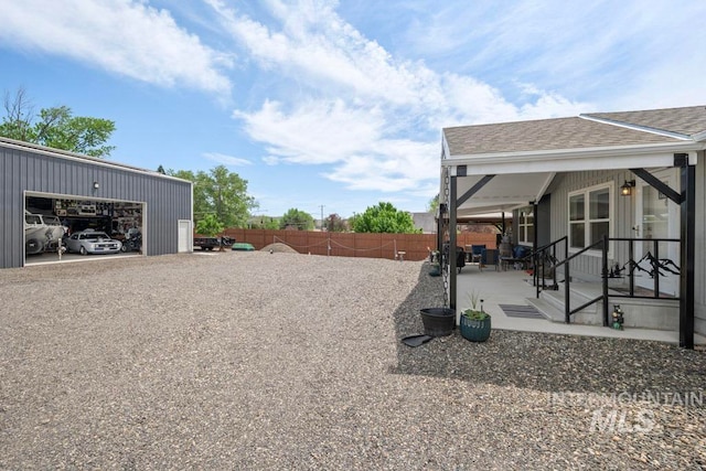 view of yard with fence and a detached garage