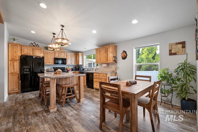 dining area featuring a chandelier, dark wood-type flooring, recessed lighting, and vaulted ceiling