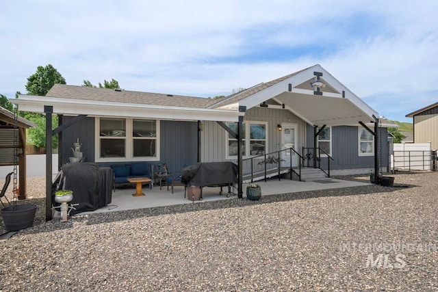 view of front of home with an outdoor living space, a patio, and fence