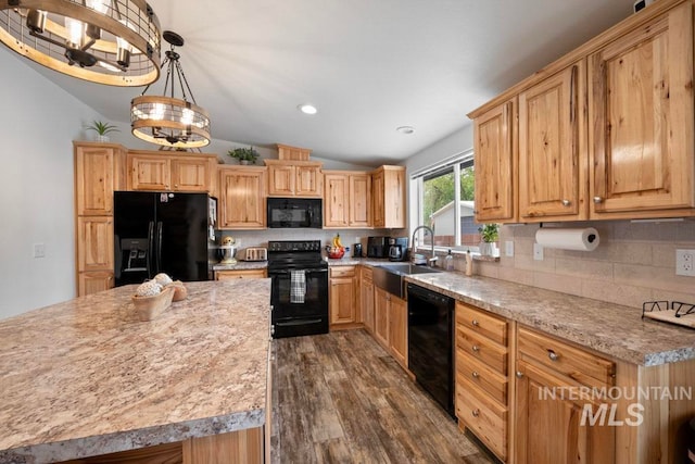 kitchen featuring black appliances, a sink, lofted ceiling, decorative backsplash, and dark wood finished floors