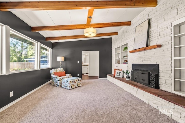 sitting room featuring carpet floors, baseboards, built in features, and a fireplace