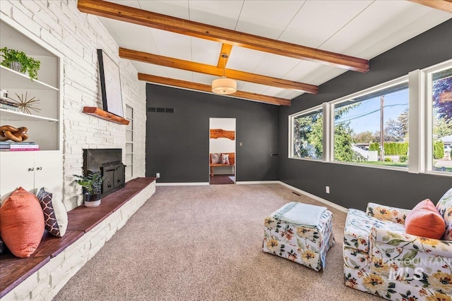 carpeted living area with baseboards, lofted ceiling with beams, a large fireplace, and visible vents